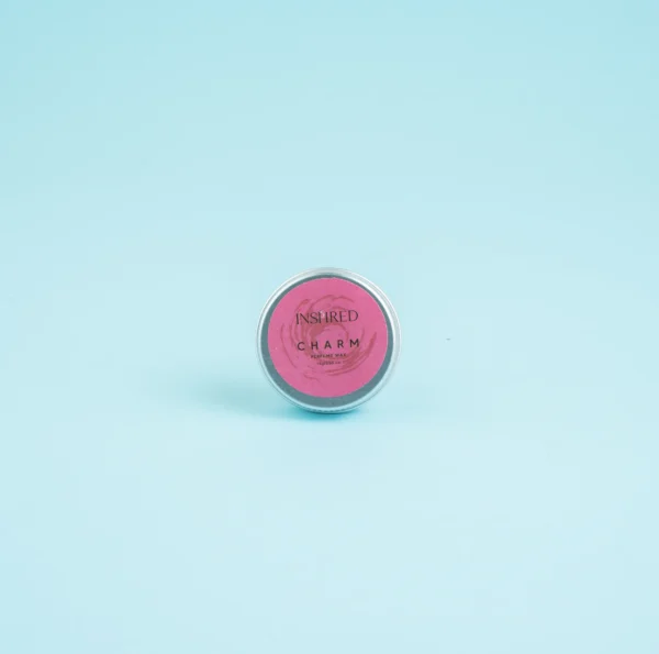 Close-up of Solid Perfume Charm tin highlighting eco‑friendly design and feminine fragrance.
