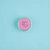 Collection of Solid Perfume Secret tins arranged stylishly, highlighting affordable luxury alternatives to Bombshell.